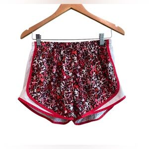 Nike: Red and White Athletic Shorts with Elastic Waistband and Curved Hem